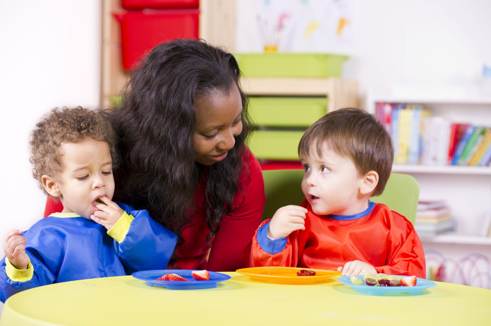 childcare worker with two children