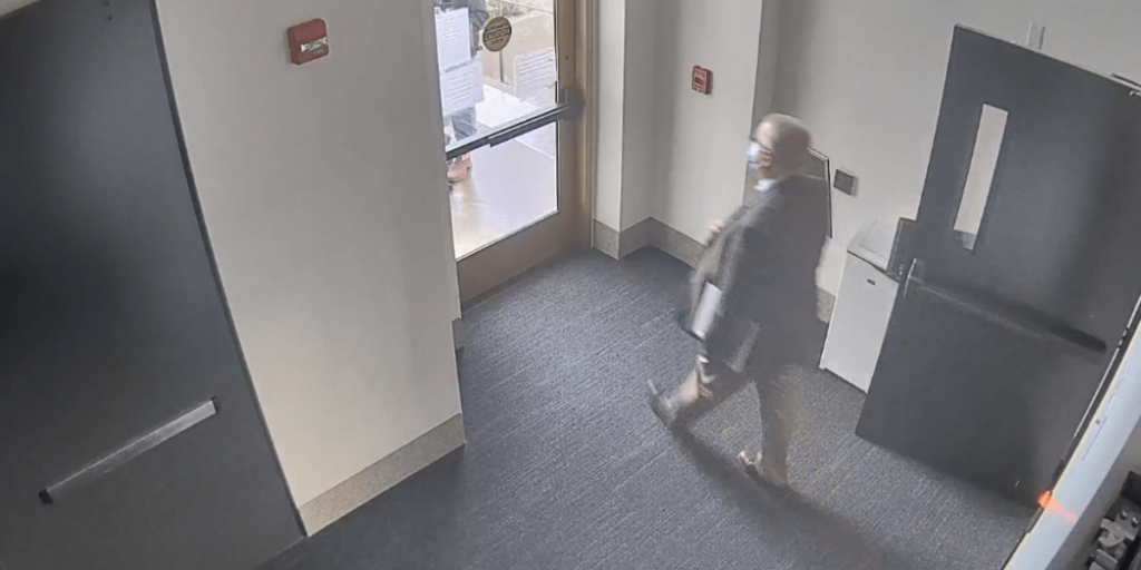 Image captured from a security camera of Rep. Mike Nearman approaching a door at the Oregon State Capitol to let right-wing protesters into the building