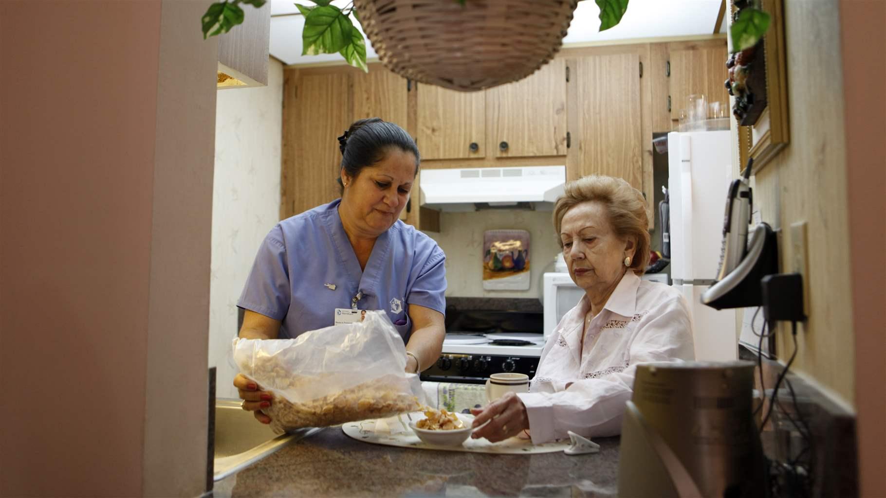 Home care worker with patient inside a kitchen